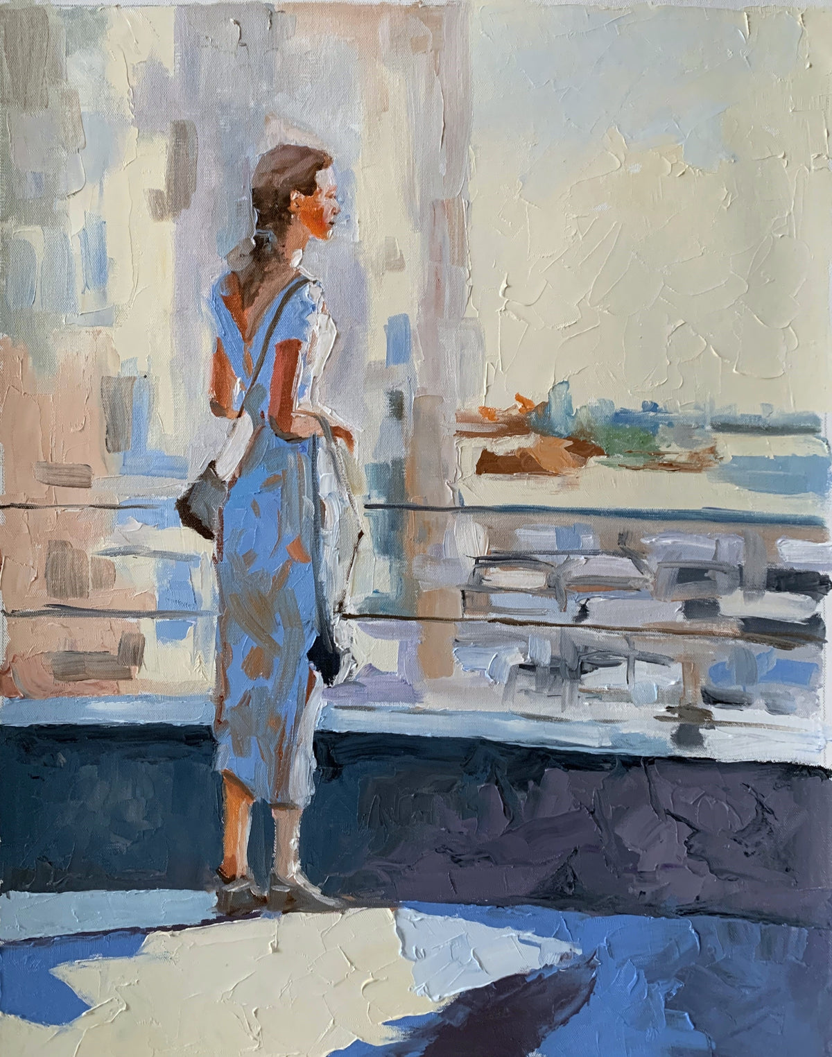 A woman in the city at sunset.