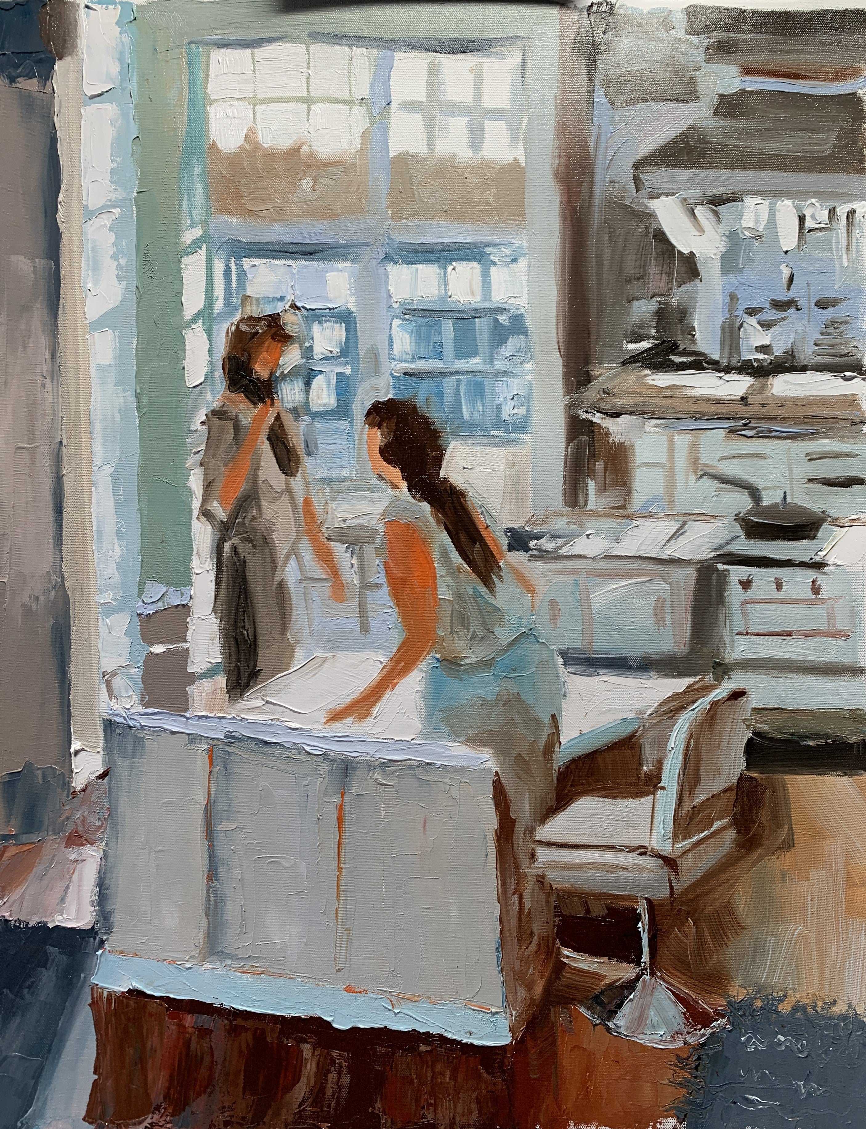 Chatting in a kitchen.